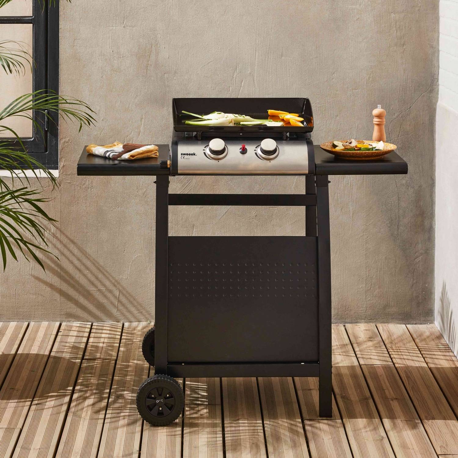 sweeek - Plancha au gaz 2 brûleurs sur chariot - Porthos - 5kW. plancha à gaz avec desserte . cuisine extérieure. plaque émaillée. inox. barbecue | sweeek - Image 1