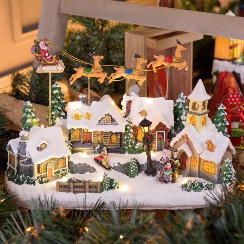 Lotti - Village de Noël LED Enneigé avec Eglise Père Noël sur Traineau Volant avec Rennes en Mouvement et Musique Lotti - Imagen 1